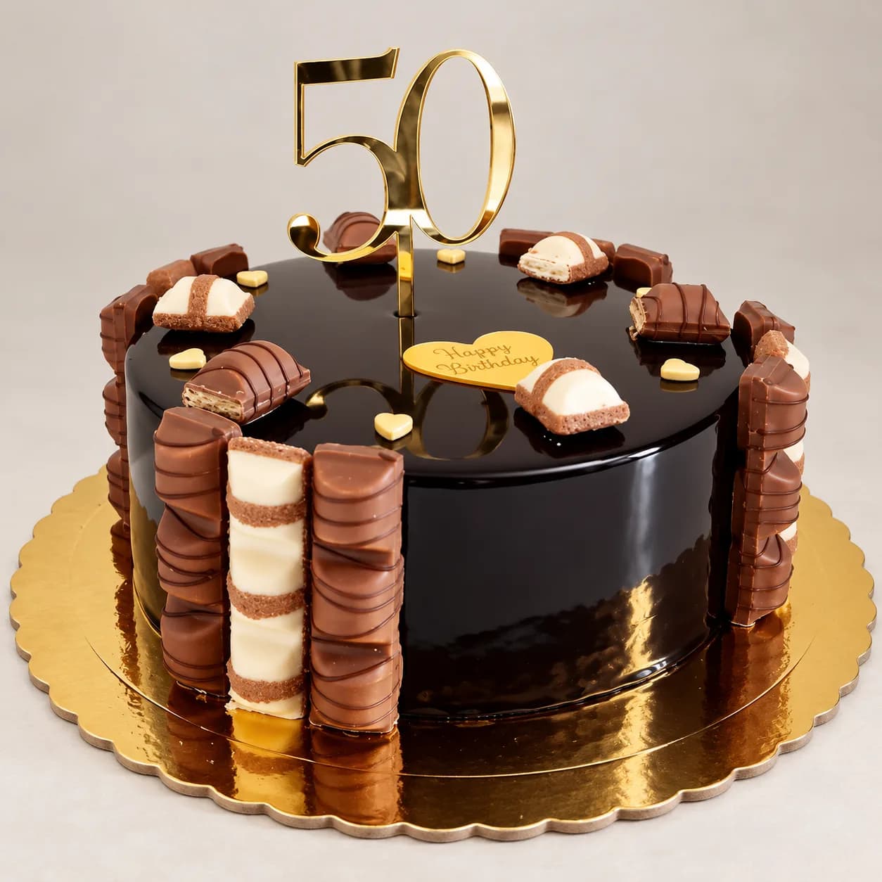 Black mirror-glaze whisky birthday cake with gold leaf and miniature bottles, made in Jersey by Sweets Land